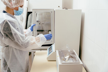 Technician placing milk sample in thermal incubator