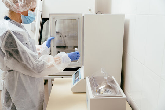 Technician placing milk sample in thermal incubator