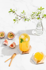 tropical Bubble Tea, Isolated on White Background. Colorful, Fresh Orange Boba Drink with Fruit Fizzy Jellies and Ice Cubes. Tapioca pearls. 