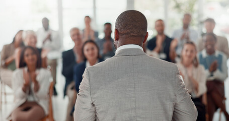Presentation, speaker and back of man with business people in office for conference, training and meeting. Corporate manager, discussion and workers in workshop, convention and seminar for finance