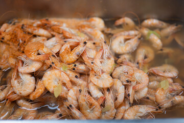 Cooked Shrimp in Hot Broth with Herbs and Steam Rising