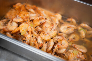 Cooked Shrimp in Hot Broth with Herbs and Steam Rising