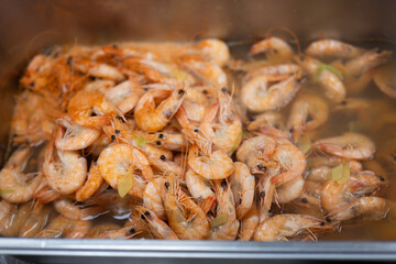 Cooked Shrimp in Hot Broth with Herbs and Steam Rising