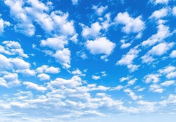 Fototapeta premium A clear blue sky dotted with white clouds.