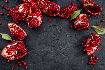 Top view of fresh ripe pomegranate with half and pieces ready for eating