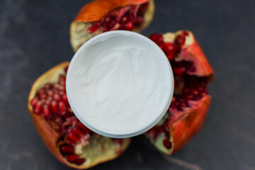 A vibrant and appealing image showcasing creamy yogurt beautifully nestled among bright pomegranate halves
