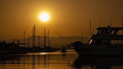Fototapeta premium The harbour of Latchi in orange colour when the sun is rising