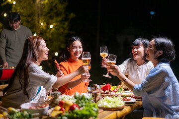 A group of women are gathered around a table, enjoying a meal