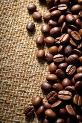 Naklejka premium Coffee beans scattered on burlap, rustic setting, cloth, store, product