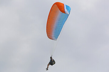 Paraglider flying in a blue sky	