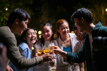 A group of people are gathered together, laughing and drinking beer