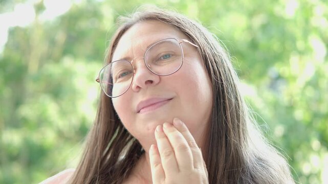 Charming mature woman with facial ptosis and developing double chin, age-related changes, aging gracefully, skin changes and gravitational sagging