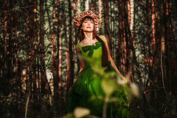 Beautiful girl in a dress in the forest