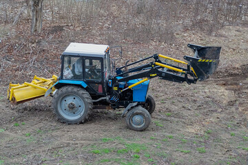 The construction loader on the open site is preparing for cleanup — a symbol of the beginning of...