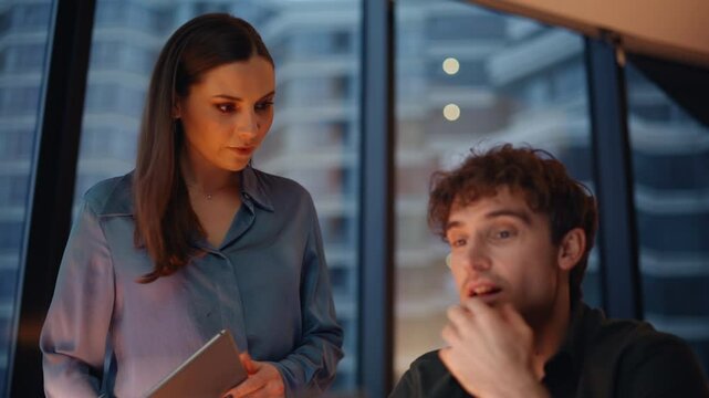 Business mentor talking intern working at laptop at evening office closeup. 