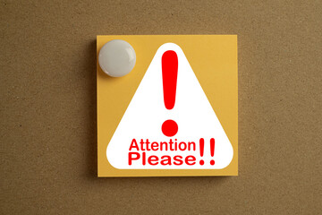 Attention please message with exclamation mark on sticky note pin on wooden board keyword for...