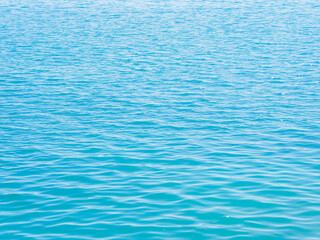 Aerial view clear blue sea background. Summer travel, at the sea in Asia, during the holiday season, giving a natural relaxing feeling. Beautiful nature environment. Travel Thailand. Ocean waves water