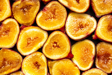 Figs close-up. Heap of figs, whole fruits and cut in half. Sweet exotic fruit for dessert, healthy food.