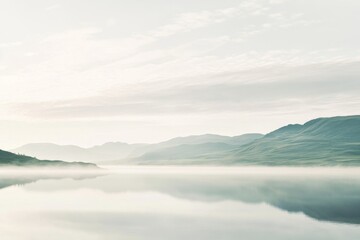 Obraz premium Misty lake sunrise over mountains