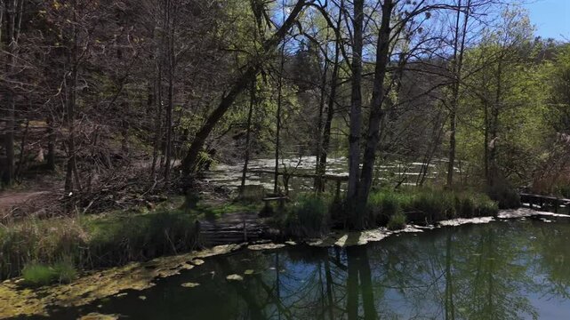 Luftaufnahme Spiegelweiher and surrounding ponds in Bavaria, Germany, Grafing bei Munchen. Scenic spring landscape with shimmering lakes, tranquil paths and flourishing nature in southern Deutschland