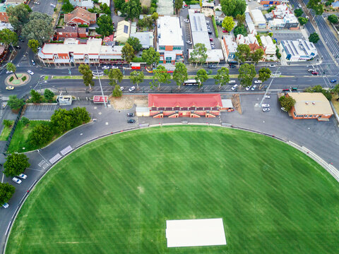 Aerial view a football oval and grandstand.