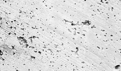 Wall fragment with scratches and cracks. Grey grunge background.