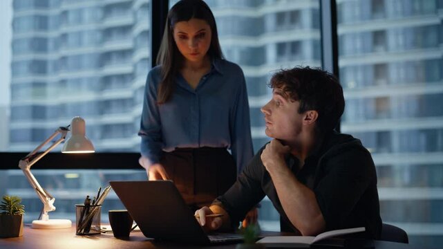 Woman boss reviewing intern work at dark office closeup. Businesswoman checking