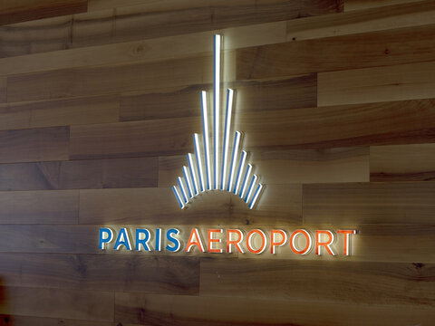 Focus on Paris Aeroport logo on a wall of wood.