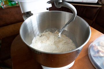making a cake in a mixer. Cake with white topping. Dessert