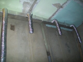 Installation of metal ductwork in a commercial building under construction in a city environment