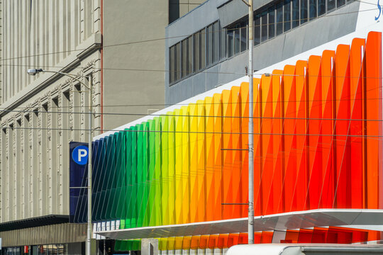 A building facade made up of rainbow coloured panels