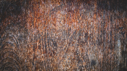 A richly detailed view of a wooden surface featuring dark grooves and organic grain formations. The texture evokes warmth and a handcrafted, natural aesthetic.