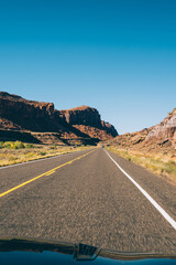 Car driving through dry rocky terrain in USA