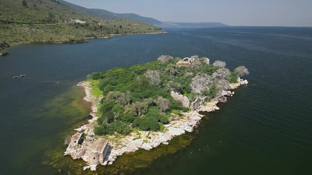 Diagonal aerial retreat from island in Turkey's Bafa Lake