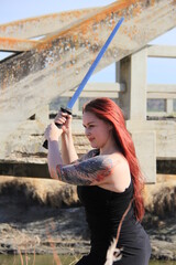 The Strong CJ Practices Her Sword Play Outdoors.