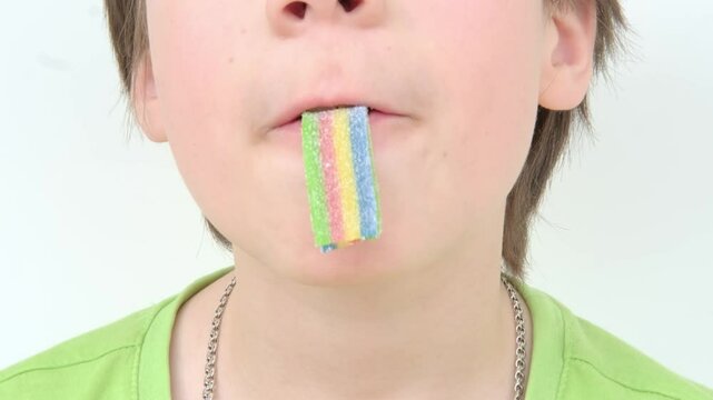 teenage child, boy eating sweet gelatin candies, looking forward to enjoying his favorite treat, unhealthy food concept, halal gelatin, unhealthy diet, happy childhood