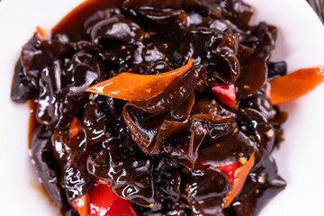 Wood ear mushrooms with vegetables on dark background. vegan food
