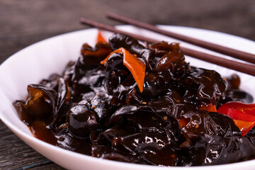 Wood ear mushrooms with vegetables on dark background. vegan food