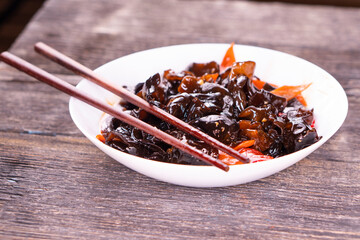 Wood ear mushrooms with vegetables on dark background. vegan food