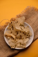 Rempeyek or Peyek is a snack or side dish made from flour with beans, shrimp, green beans, etc., fried in a flat shape. Rempeyek.kacang hijau. Indonesian food