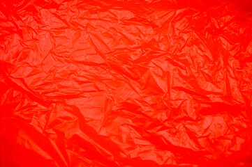A dynamic close-up of a vibrant red textured surface, with intricate crinkles and folds creating an engaging abstract visual