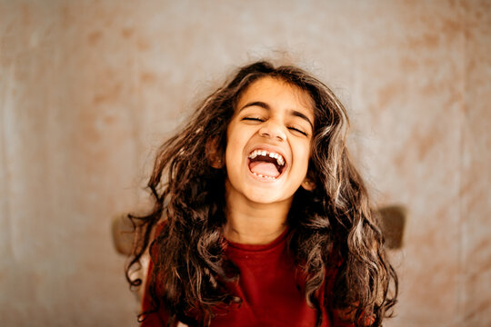 joyful and candid moment of a little girl laughing wholeheartedly