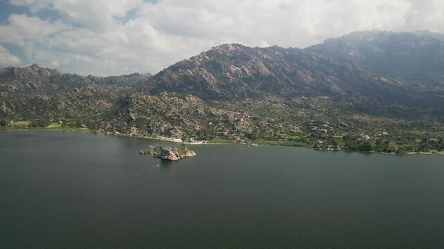 Distant approach to island in scenic Turkish Bafa Lake