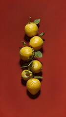 Strawberries in delectated mood and unnatural colors on different background
