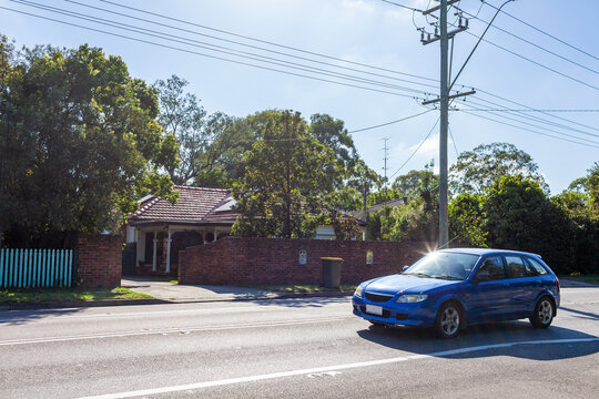 Car traveling on highway through country town of Singleton