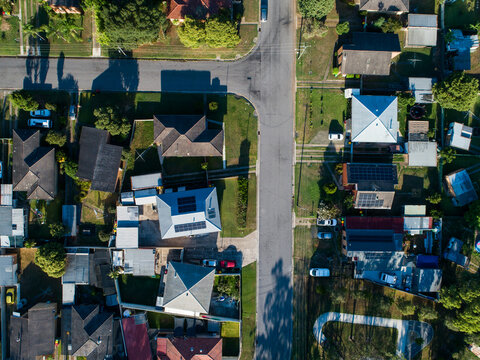 Aerial view of Singleton streets and homes in town on sunlit morning in summer