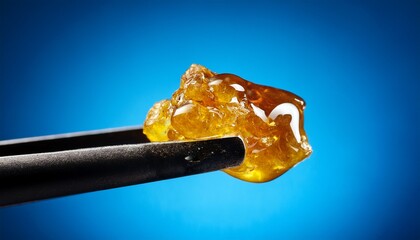 live rosin on a dab tool with a blue background