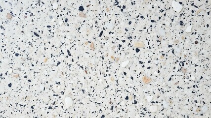 Naklejka premium Terrazzo Stone Texture: An intricate, detailed macro view captures the mesmerizing beauty of a terrazzo stone surface, with its mosaic of speckled aggregate.