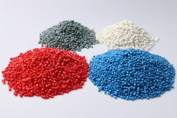 Pile of various colors of masterbatch plastic granules arranged on a white background, Polymer plastic beads resin polymer