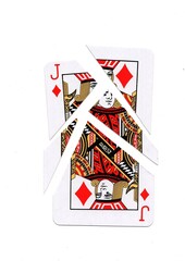 A playing card in the suit of diamonds cut into sharp pieces.